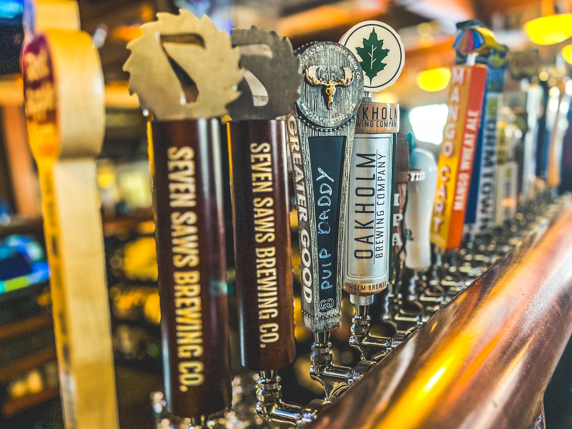 Bar beer taps highlighting Seven Saws Brewery, Oakholm Brewery, Greater Good Brewery, and more